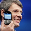 Thorsten Heins holding a Blackberry phone.