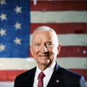 Ross Perot photo in front of an American flag.