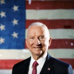 Ross Perot photo in front of an American flag.